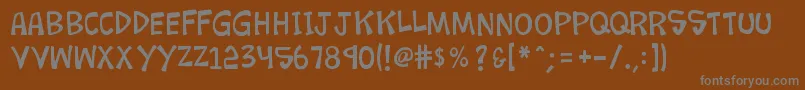 K26loremipsum-Schriftart – Graue Schriften auf braunem Hintergrund