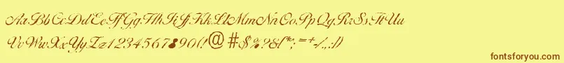 フォントBallantinesantiqueLightRegular – 茶色の文字が黄色の背景にあります。