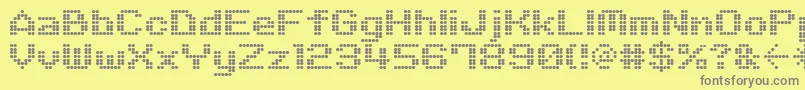 M06Quadra-fontti – harmaat kirjasimet keltaisella taustalla