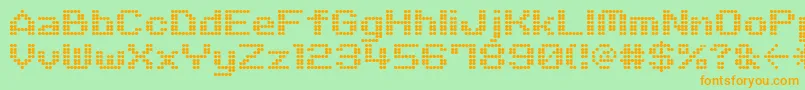 フォントM06Quadra – オレンジの文字が緑の背景にあります。