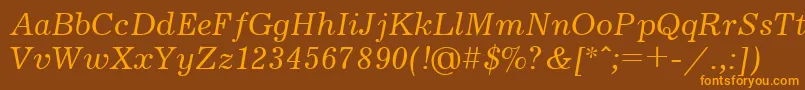 フォントUkrainianjournalItalic – オレンジ色の文字が茶色の背景にあります。
