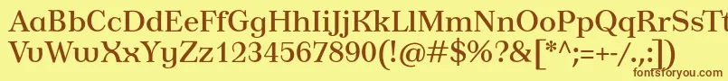 フォントTusardecotext – 茶色の文字が黄色の背景にあります。