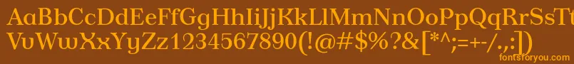 フォントTusardecotext – オレンジ色の文字が茶色の背景にあります。