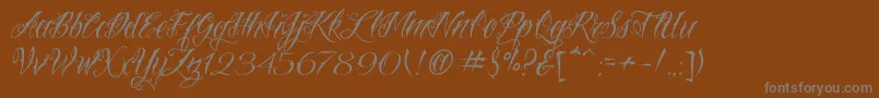 Fonte VtcNuetattooscript – fontes cinzas em um fundo marrom