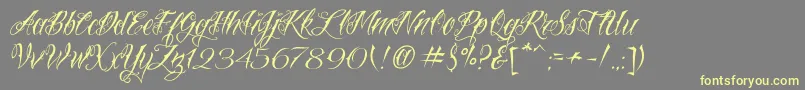 VtcNuetattooscript-Schriftart – Gelbe Schriften auf grauem Hintergrund