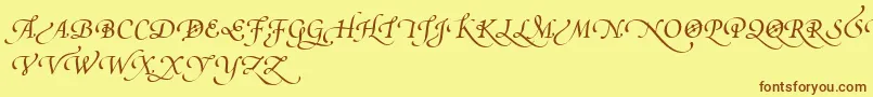 フォントPoeticaSuppSwashCapitalsIv – 茶色の文字が黄色の背景にあります。