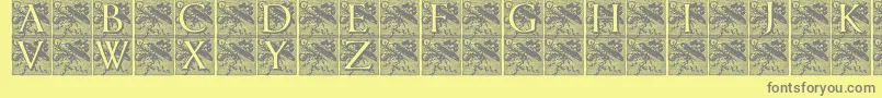 Pompadourinitials-fontti – harmaat kirjasimet keltaisella taustalla