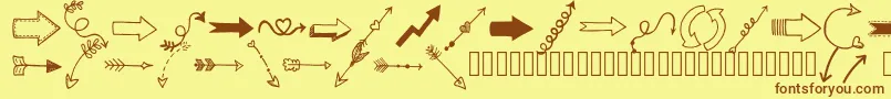 Czcionka Tanaesteldoodlearrows01Regular – brązowe czcionki na żółtym tle