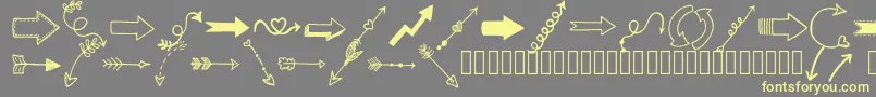 Tanaesteldoodlearrows01Regular-fontti – keltaiset fontit harmaalla taustalla