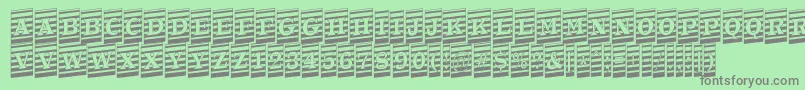 ATrianglercmmrup-fontti – harmaat kirjasimet vihreällä taustalla