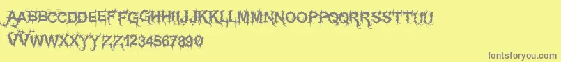 Vtksespinhuda-Schriftart – Graue Schriften auf gelbem Hintergrund