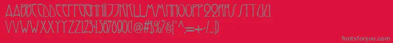 フォントReynoldartdeco – 赤い背景に灰色の文字