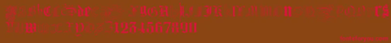 フォントKidnappedAtGermanLands – 赤い文字が茶色の背景にあります。