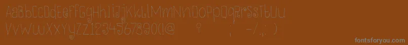 DkThievery-fontti – harmaat kirjasimet ruskealla taustalla