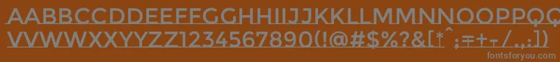 MontserratsubrayadaRegular-fontti – harmaat kirjasimet ruskealla taustalla