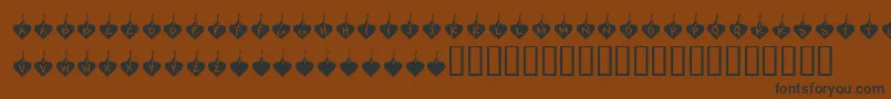 フォントKrBurningLove – 黒い文字が茶色の背景にあります
