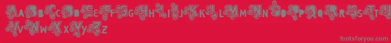 フォントVtkscapsloco – 赤い背景に灰色の文字