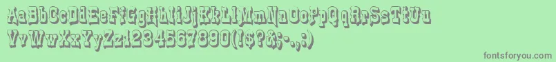 フォントGePlasterDrip – 緑の背景に灰色の文字