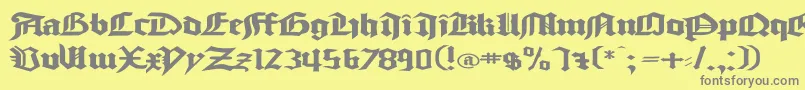 GoodcitymodernPlainExPlain-fontti – harmaat kirjasimet keltaisella taustalla