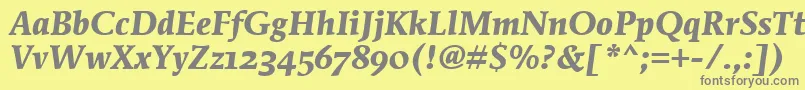 MendozaRomanOsItcTtBoldita-fontti – harmaat kirjasimet keltaisella taustalla
