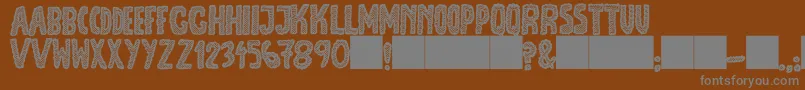 Шрифт JmhEscamasBlack – серые шрифты на коричневом фоне