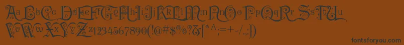 フォントP22KilkennyInitialCap – 黒い文字が茶色の背景にあります