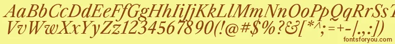 フォントLibrecaslontextItalic – 茶色の文字が黄色の背景にあります。