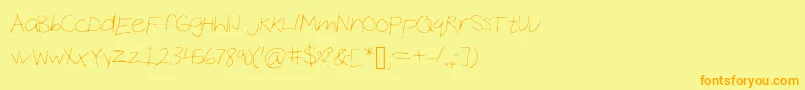 フォントCocoHand – オレンジの文字が黄色の背景にあります。