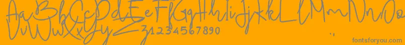 BudhayantiScript-Schriftart – Graue Schriften auf orangefarbenem Hintergrund