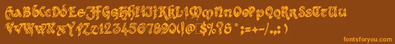 フォントKingthings – オレンジ色の文字が茶色の背景にあります。