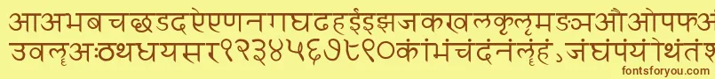 フォントSanskritwriting – 茶色の文字が黄色の背景にあります。