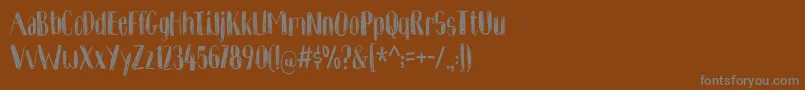 フォントKomfortabelDemo – 茶色の背景に灰色の文字