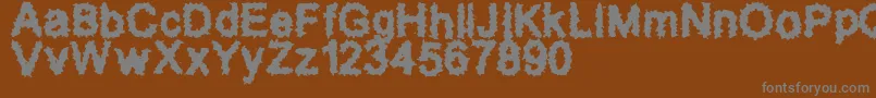 SplatzBrk-fontti – harmaat kirjasimet ruskealla taustalla