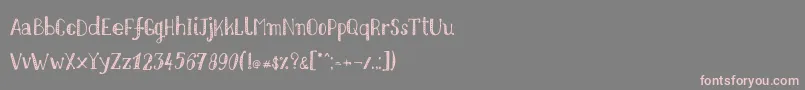 Czcionka Nikolaidishand – różowe czcionki na szarym tle