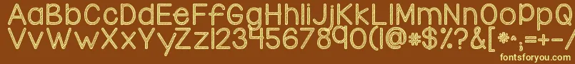 Kgcandycanestripe-fontti – keltaiset fontit ruskealla taustalla