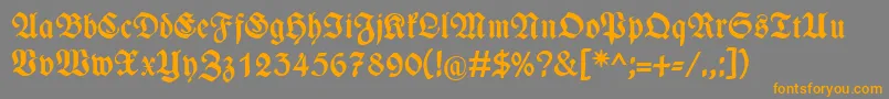 フォントWieynckfrakturFettunz1l – オレンジの文字は灰色の背景にあります。