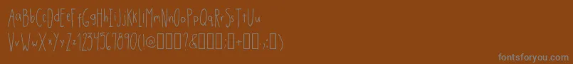 Шрифт DrmhandwrittenthinRegular – серые шрифты на коричневом фоне