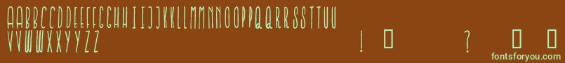 フォントIronFurnaces – 緑色の文字が茶色の背景にあります。