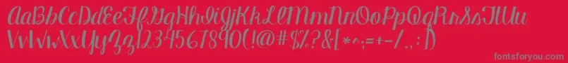 フォントKgmanhattanscript – 赤い背景に灰色の文字
