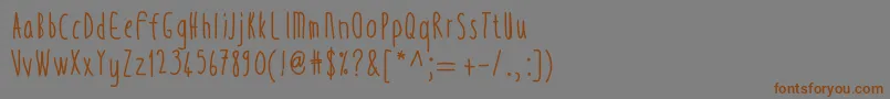 フォントThintall – 茶色の文字が灰色の背景にあります。