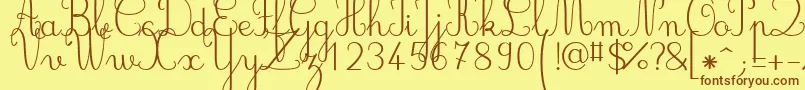 フォントJbcursive – 茶色の文字が黄色の背景にあります。