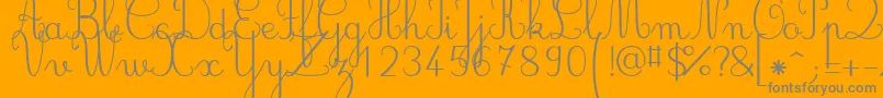 Jbcursive-fontti – harmaat kirjasimet oranssilla taustalla