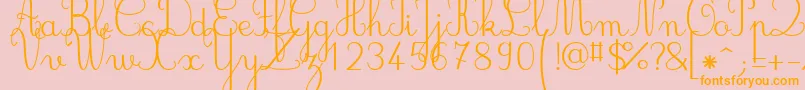 フォントJbcursive – オレンジの文字がピンクの背景にあります。