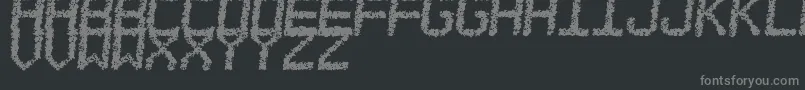 EstoreaTfb-fontti – harmaat kirjasimet mustalla taustalla