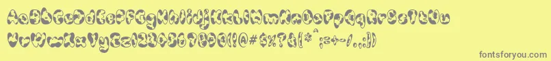 フォントCowpokeBi – 黄色の背景に灰色の文字