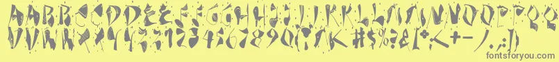 Dekonitials-fontti – harmaat kirjasimet keltaisella taustalla