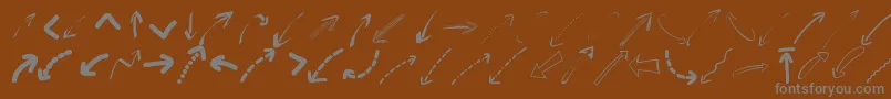 Czcionka Peaxwebdesignarrows – szare czcionki na brązowym tle