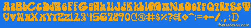 フォントShagadelicBold – オレンジ色の文字が青い背景にあります。