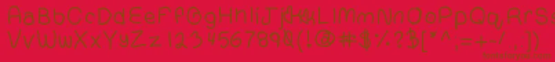 フォントCompressedhand – 赤い背景に茶色の文字