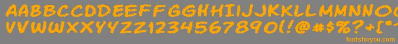 フォントKomikaTread – オレンジの文字は灰色の背景にあります。